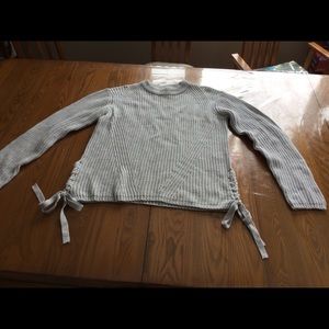 Knitted sweater with interesting lines and ties at the side hem, size L